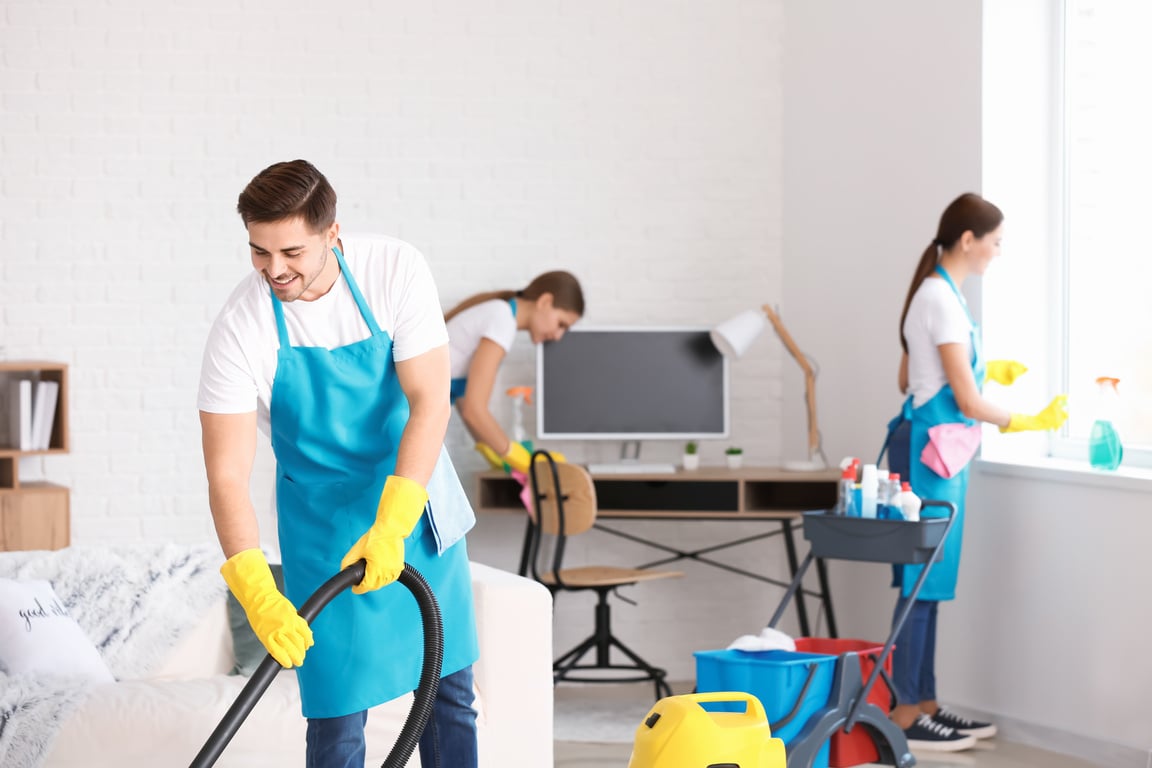 Team of Janitors Cleaning Flat